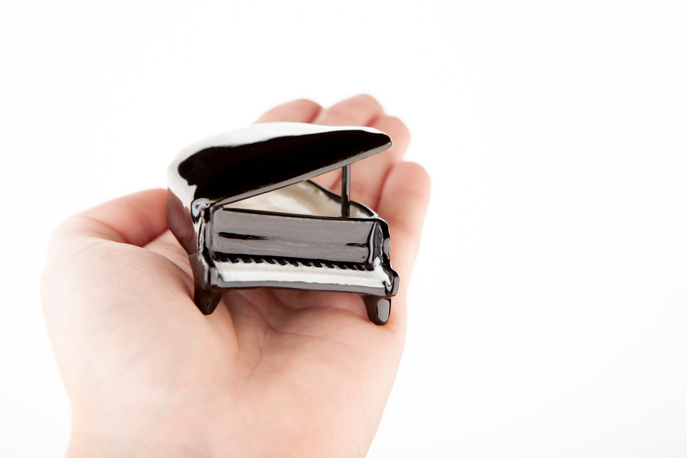 Model of a Piano Resting in an Open Hand