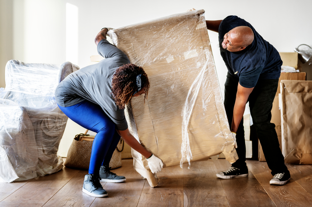 Couple moves heavy furniture together